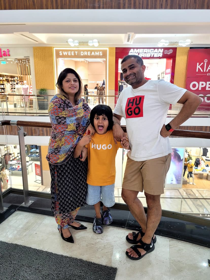 Vyom holding hands with his Mom and Dad full of cheerful energy